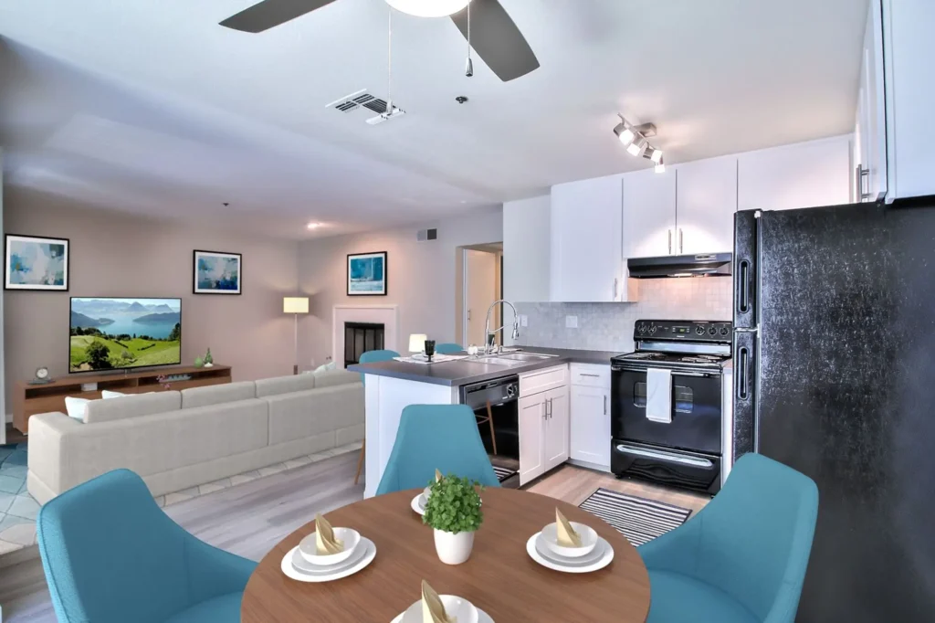 Kitchen with black appliances and tile backsplash