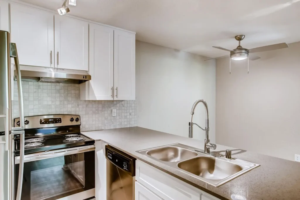 Kitchen with stainless steel appliances and tile backsplash