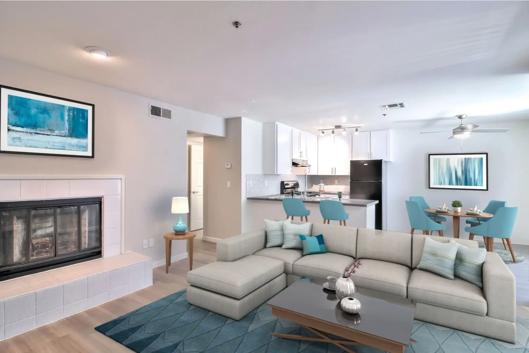 Living room with fire place, looking into the kitchen and dining