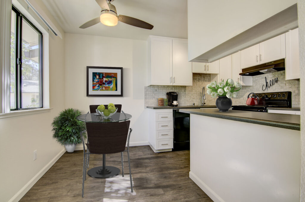 Kitchen with black appliances and tile backsplash